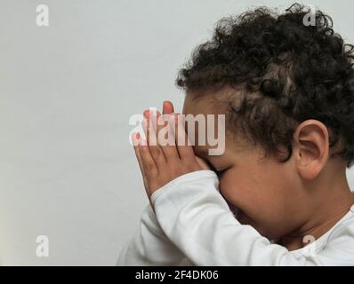 Junge beten zu Gott mit den Händen zusammen auf weißem Hintergrund Stock Foto Stockfoto