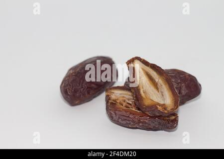 Getrocknete Früchte mit geteiltem Dattdatum. Getrocknete Datteln isoliert auf weißem Hintergrund. Das Beste vom Ramadan-Essen Stockfoto