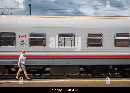 Ein Waggonwart der Provodnitsa am Bahnhof Nowosibirsk-Glavny in Nowosibirsk, Russland, ein wichtiger Halt entlang der Transsibirischen Eisenbahn. Stockfoto