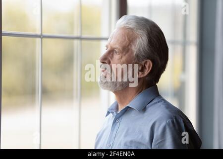 Unglücklicher älterer Mann schaut in der Ferne einsam Stockfoto