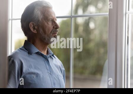 Unglücklicher älterer Mann schaut in der Ferne vermisst Stockfoto