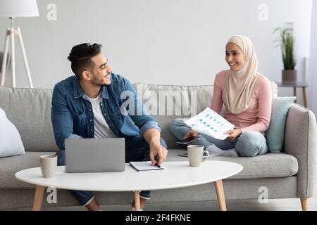 Junge arabische Paar auf der Suche nach Krankenversicherung im Internet Stockfoto