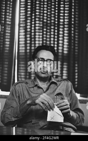 Halblanges Porträt des kubanischen Revolutionärs Cesar Escalante vor einem gemusterten Stoffhintergrund, Kuba, 1964. Aus der Sammlung Deena Stryker Photographs. () Stockfoto