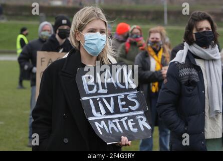 Amsterdam, Niederlande. März 2021, 21st. Eine Frau, die eine schützende Gesichtsmaske trägt, hält eine placa mit dem Schild "Black Lives Matter" während einer gemeinsamen Demonstration gegen Rassismus und Faschismus im Wester Park inmitten der Coronavirus-Pandemie am 21. März 2021 in Amsterdam, Niederlande. Die Demonstration wird von der Gruppe Komitee März 21, Anti-Rassismus-Koalition, als Ausdruck der Einheit gegen Rassismus, Islamophobie und Antisemitismus organisiert. (Foto von Paulo Amorim/Sipa USA) Quelle: SIPA USA/Alamy Live News Stockfoto