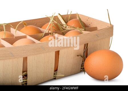 Eierschale aus Holz mit Heu isoliert auf weißem Hintergrund Stockfoto