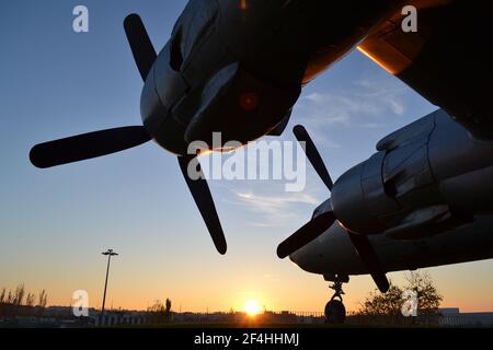 Douglas DC-7 Transportflugzeug am Ufer des Guadalquivir-Flusses, Córdoba, Spanien. Propeller, Motoren, die Nase & Heckflosse, am frühen Abend Sonnenuntergang. Stockfoto