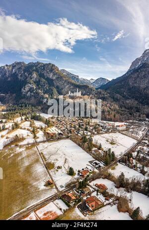 Luftdrohnenaufnahme des malerischen Schlosses Neuschwanstein auf einem verschneiten Hügel Im Winter Sonnenlicht in Deutschland Stockfoto