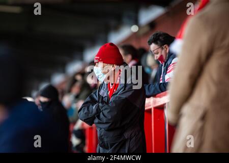 Fans und Zuschauer beobachten Fußballspiele der unteren Liga während der Coronavirus-Pandemie Covid-19 in England, Großbritannien. Tragen von Gesichtsbezügen und Gesichtsmasken. Stockfoto