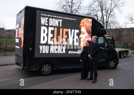 Glasgow, Großbritannien, am 23. März 2021. ÔSturgeon ResignÕ und ÔWe DonÕt Believe You NicolaÕ Kommentar auf der Seite eines digitalen Display-Van, der Nicola SturgeonÕs Wahlkreis in Govanhill, Glasgow und später heute vor dem schottischen Parlamentsgebäude in Edinburgh umrundet, bezahlt durch Crowdfunded-Kampagne von der Mehrheit (im Besitz von Mary und Mark Devlin, im Bild). Foto: Jeremy Sutton-Hibbert/Alamy Live News. Stockfoto