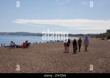 Menschen, die am Strand von Overcombe in Dorset in Großbritannien spazieren, aufgenommen am 3. August 2020 Stockfoto