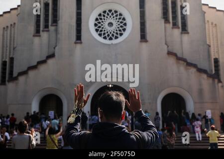 Ein Gläubiger hebt seine Hände während einer Aschermittwochmesse in der Redemptoristenkirche in Baclaran, Metro Manila. Millionen philippinischer Anhänger strömten in Kirchen im ganzen Land, um den Beginn der Fastenzeit zu beobachten, trotz der Einschränkungen, die durch COVID-19 verursacht wurden. Die Katholische Bischofskonferenz der Philippinen (CBCP) empfahl, Asche auf die Köpfe von Anhängern zu legen, um die physische Distanzierung inmitten der neuartigen Coronavirus-Pandemie aufrechtzuerhalten. Philippinen. Stockfoto