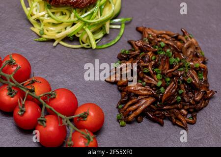 Zucchini-Spaghetti mit getrockneten und getrockneten Tomaten Stockfoto