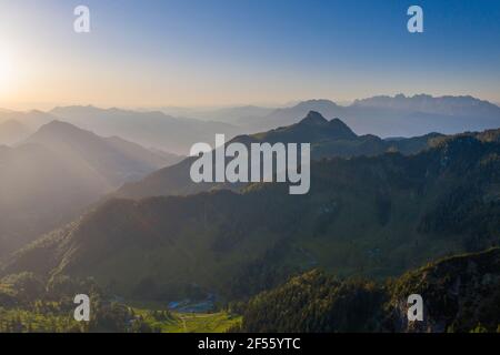 Die Sonne geht über dem nebligen Tal in den Mangfall Mountains auf Stockfoto