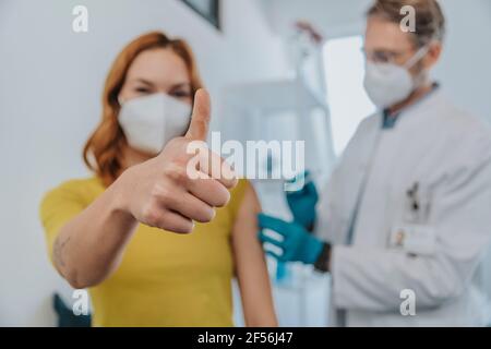 Patient, der bei der Untersuchung den Daumen nach oben stamuliert, während er beim Arzt sitzt Zimmer Stockfoto