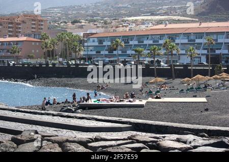Mai 2017. Las Caletillas, Teneriffa, Spanien. Panoramablick über den Strand von Las Caletillas mit Badegäste Sonnenbaden auf dem schwarzen Sand und unter dem um Stockfoto