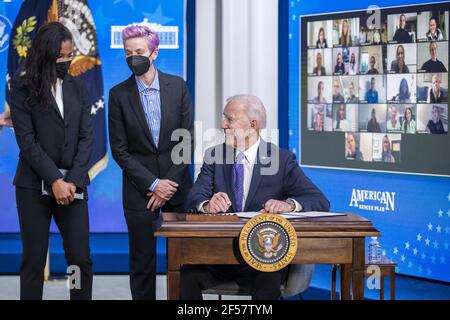 Washington, Usa. März 2021, 24th. US-Präsident Joe Biden, mit Margaret Purce (L), Megan Rapinoe (C) und anderen Mitgliedern der US-Fußball-Frauen-Nationalmannschaft, unterzeichnet eine Proklamation während einer Veranstaltung zum Tag der Entlohnung im Staatlichen Speisesaal des Weißen Hauses in Washington, DC am 24. März 2021. Equal Pay Day markiert die zusätzliche Zeit, die es dauert eine durchschnittliche Frau in den Vereinigten Staaten, um den gleichen Lohn zu verdienen, dass ihre männlichen Kollegen im vorherigen Kalenderjahr. Pool Foto von Shawn Thew Kredit: UPI/Alamy Live Nachrichten Stockfoto