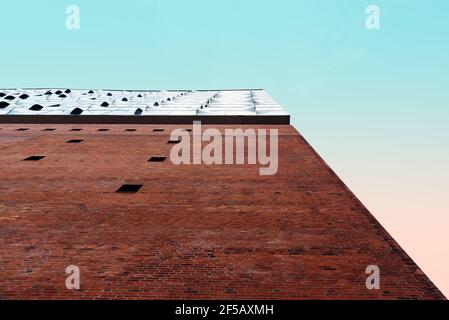 Hamburg, Deutschland - 7. August 2019: Low-Angle-Ansicht der Elbphilharmonie Hamburg gegen rosa und blauen Himmel. Minimalismus und Geometriekonzept. Stockfoto