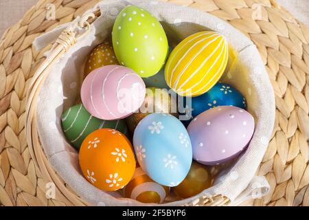 Ostern bunte Eier in busket auf weißem Holztisch. Frohe Ostern Hintergrund. Stockfoto