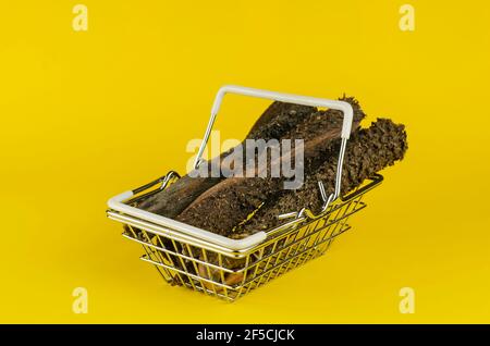 Warenkorb mit Hundefutter auf gelbem Hintergrund. Natürliche getrocknete Kau Leckereien für Haustiere. Kutteln von getrocknetem Rindfleisch. Haustierbedarf. Stockfoto