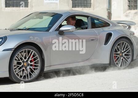 Regensburg, Deutschland. März 2021, 26th. Mehrfacher Rallye-Weltmeister Walter Röhrl startet im Porsche 911 Carrera im Hof der Regensburger Südpolizei anlässlich der Vorstellung eines Fahrsicherheitkonzeptes gegen Autoposer einen Kavalierstart. Ziel der Polizei ist es, durch präventive und repressive Maßnahmen das Bewusstsein der Autofahrer für das Fahren unter Einhaltung der Regeln und der ordnungsgemäßen Ausrüstung ihrer Fahrzeuge zu schärfen. Quelle: Timm Schamberger/dpa/Alamy Live News Stockfoto