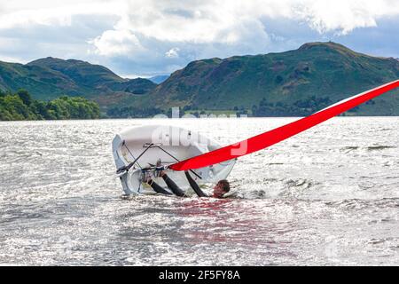 The English Lake District - Segeln auf Ullswater, Cumbria UK - EIN junger Mann kentert ein Schlauchboot Stockfoto