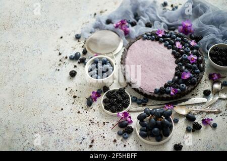 Hausgemachte Brombeerherbe. Süßer Kuchen mit Bromberrym Heidelbeere und Trauben auf Stein Tisch Stockfoto