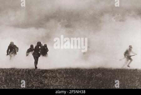 Deutsche Soldaten, die im Ersten Weltkrieg durch Rauch auf dem Schlachtfeld vorrückten. Stockfoto