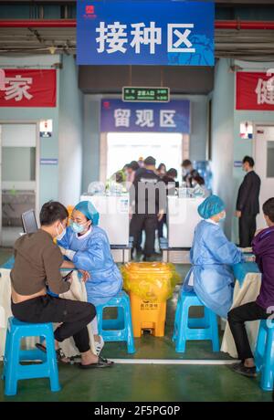 Chongqing, China. März 2021, 27th. Die Menschen erhalten COVID-19-Impfstoffe an einer temporären Impfstelle im Bezirk Jiulongpo in Chongqing, Südwestchina, 27. März 2021. In zwei Sportzentren im Bezirk Jiulongpo und im Bezirk Nan'an in Chongqing wurden zwei temporäre Impfstellen eingerichtet, die eine tägliche Impfkapazität von etwa 5.000 bzw. 10.000 haben. Quelle: Huang Wei/Xinhua/Alamy Live News Stockfoto