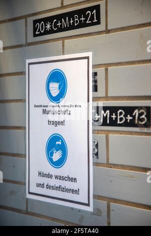 deutsches Schild an einer Wand an einem Ladeneingang, um beim Betreten des Ladens Mundschutz zu tragen, wegen Corona-Virus. Zeichen bedeckt den Segen von Ep Stockfoto