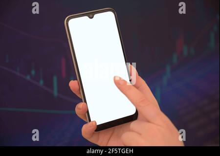 Mockup Bild von Frauen Hände halten Handy mit leer Bildschirm über verschwommenem Börsenhintergrund Stockfoto