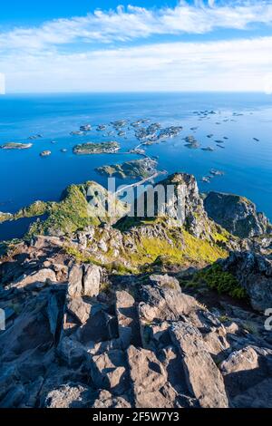 Kleine Felseninseln im Meer, Blick vom Gipfel des Festvagtind auf das Dorf Henningsvaer, Vagan, Lofoten, Nordland, Norwegen Stockfoto