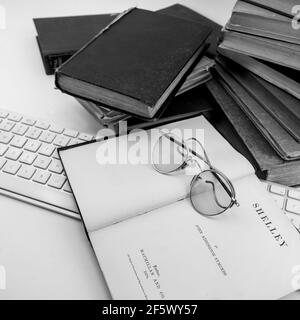 Seltene alte Vintage-Bücher aus der Bibliothek Shelley Gedichte, oben auf einer alten Brille auf weißem Hintergrund Stockfoto