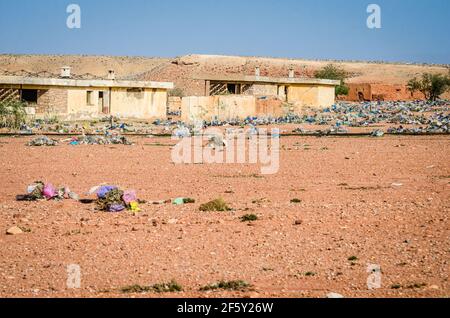 Aouli, Marokko - 10. April 2015. Riesige Menge Müll, verteilt in der Wüste zwischen verlassenen Ruinen Stockfoto