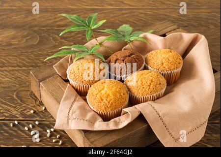 Marihuana Cupcake Muffins und Cannabisblätter auf einem weißen Teller. Hausgemachte Speisen. Horizontale Ausrichtung. Blick von oben Stockfoto