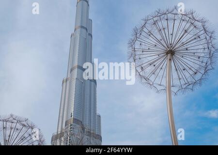 DUBAI, VEREINIGTE ARABISCHE EMIRATE - 10. FEBRUAR 2021: Bottom-up-Ansicht des Burj Khalifa im Kontrast zum blauen Himmel und den Wolken. Burj khalifa, der höchste BU Stockfoto