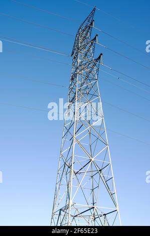 Strommast für den Transport von Elektrizität mit einem klaren Blau Himmel Stockfoto