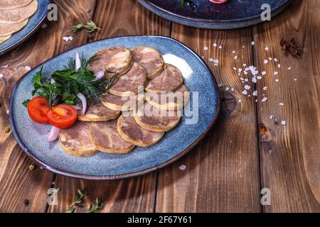 Fleisch- und Wurstaufschnitt, Knoblauch, Chilischoten, Tomaten und andere Gewürze auf einem braunen Hintergrund. Restaurant-Service. Stockfoto