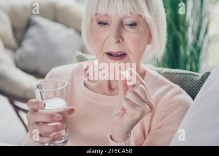 Cropped Nahaufnahme Porträt von attraktiven kranken grauhaarigen Frau nehmen Pillen Infektion Influenza-Therapie in Haus Wohnung drinnen Stockfoto