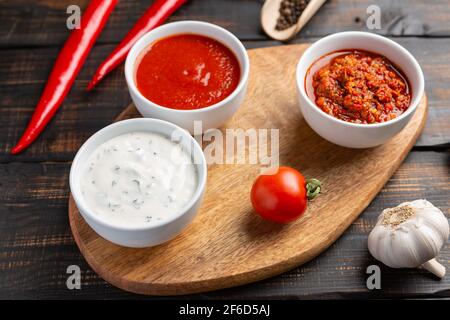 Variationen von verschiedenen Arten von Soßen. Auf dunklen rustikalen Hintergrund Stockfoto