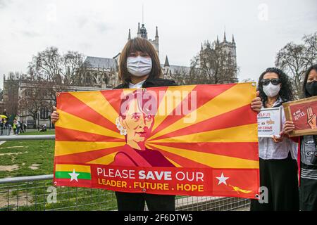 WESTMINSTER LONDON, GROSSBRITANNIEN 31. MÄRZ 2021. Mitglieder der birmanischen Gemeinde demonstrieren auf dem Parliament Square mit Plakaten und Schildern gegen die in Myanmar verhängte Militärdiktatur und fordern die Wiederherstellung der Demokratie und die Freilassung von Aung San Suu Kyi, die seit Februar 2021 unter Hausarrest gestellt wird. Viele Menschen wurden seit der militärischen Übernahme des Landes im vergangenen Monat von Sicherheitskräften in Myanmar getötet.Credit amer ghazzal/Alamy Live News Stockfoto