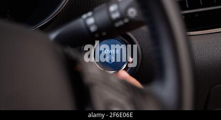 Frau, Die Den Motor-Start-Knopf Und Den Zündschalter Drückt Stockfoto