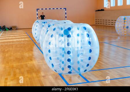 Bunte Bumper Ball Luftballons in der Sporthalle. Ausrüstung für Teambuilding Sportspiel namens Bumper boll oder Bubble Ball. Zorbsoccer. Stockfoto