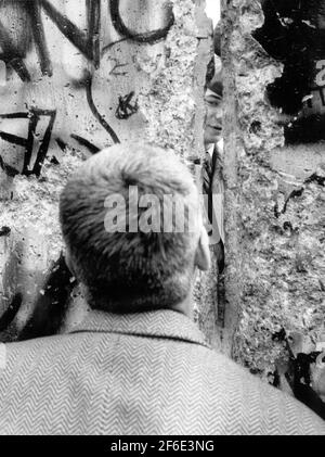 Berlin 1989-11-15 der Fall der Berliner Mauer, die Grenzöffnung. Ein Mann, der durch einen Riss in der Wand schaut. Foto: Sven-Erik Sjoberg / DN / TT / Code 53 Stockfoto