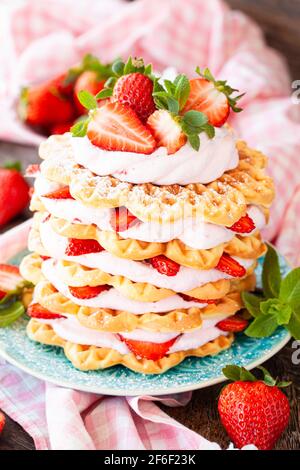Waffeln mit Schlagsahne und frischen Erdbeeren gestapelt Stockfoto