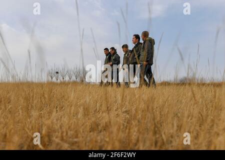 (210331) -- BAICHENG, 31. März 2021 (Xinhua) -- Mitglieder des Zhenlai Vogelschutzteams der China Wildlife Conservation Association beobachten Zugvögel im Bezirk Zhenlai, Stadt Baicheng, nordöstlich der Provinz Jilin, 31. März 2021. Eine Gruppe von Menschen gehen oft langsam und sprechen mit leiser Stimme am Rande des Feuchtgebiets im Bezirk Zhenlai, wenn das Wetter sich erwärmt. Manchmal nehmen sie ein Fernglas auf, um nach draußen zu schauen, und manchmal beugen sie ihren Kopf, um die geographischen Koordinaten auf ihren Mobiltelefonen aufzuzeichnen. Sie sind Mitglieder des Zhenlai Vogelschutzteams der China Wildlife konserven Stockfoto