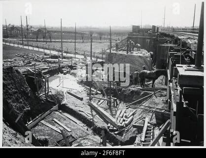 Wiederaufbau des Viadukts über die Malmö Ystads Eisenbahn, auf der Strecke zwischen Malmö und Trelleborg. Betonguß für Sohle auf die neue Land Bracket. Aushub für die Basis für Pendel und Abriss der alten Landklammer. Stockfoto
