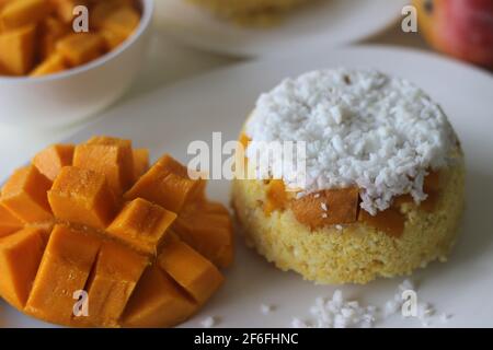 Gedämpfter gemahlener Reis, geschichtet mit Kokosraspeln und Mango. Lokal bekannt als Mango Puttu. Ein traditionelles gesundes Frühstücksgericht von Kerala. Schuss auf WH Stockfoto