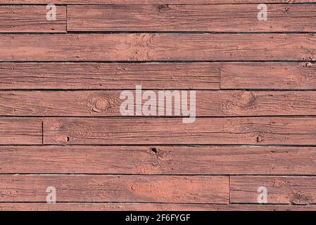 Alte Holzplanken Wandhintergrund. Schroffe Holzstruktur. Abstraktes Muster aus rostbraunen Holzplatten Stockfoto