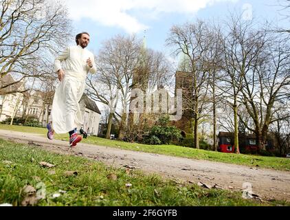 Duisburg, Deutschland. März 2021. Pater Tobias läuft an der Herz-Jesu-Kirche vorbei. Vater hat bereits mehr als 100 Marathons gelaufen. Das Geld (1.5 Millionen Euro) wird für Projekte für bedürftige Menschen verwendet. Quelle: Roland Weihrauch/dpa/Alamy Live News Stockfoto