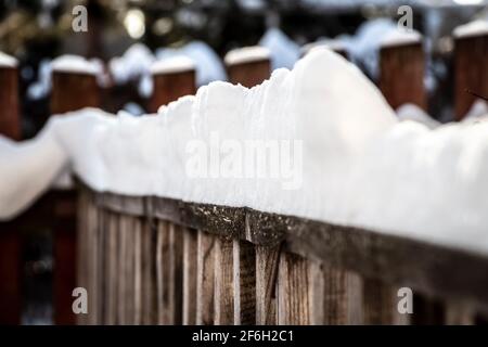 Ländliche Holzzaun bedeckt mit frisch gefallenen Schnee. Stockfoto